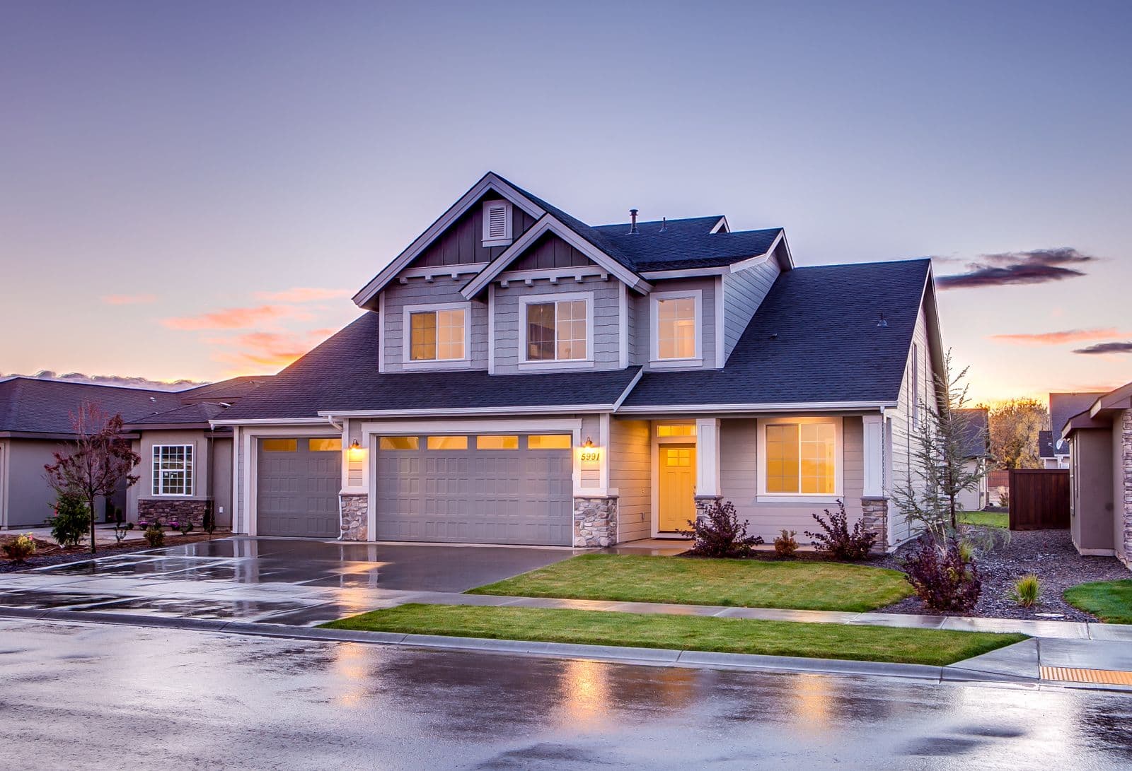 A warm, well-insulated home glowing at dusk
